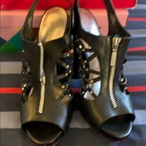 Black with silver studs and middle zip pump